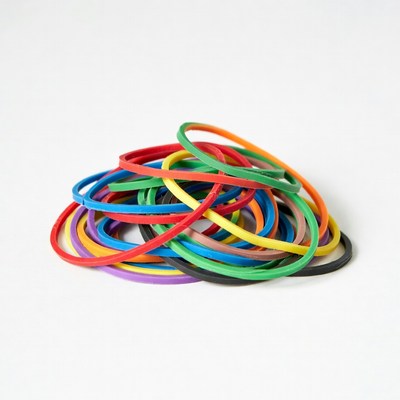 Colorful rubber bands on white surface