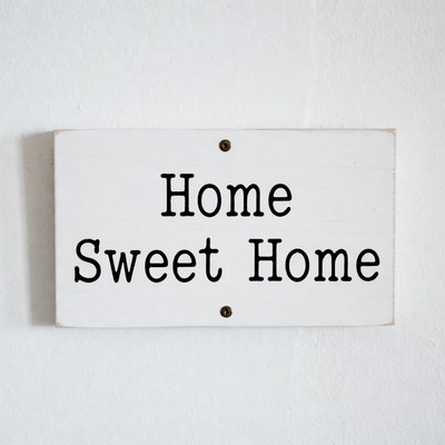 Sign with home sweet home message on wall