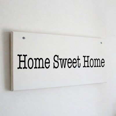 Home sign on a wall in kitchen