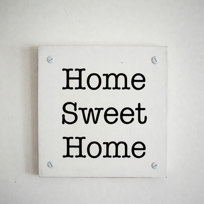 Home plaque on white wall