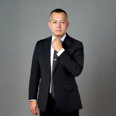 Man in suit adjusting tie in studio