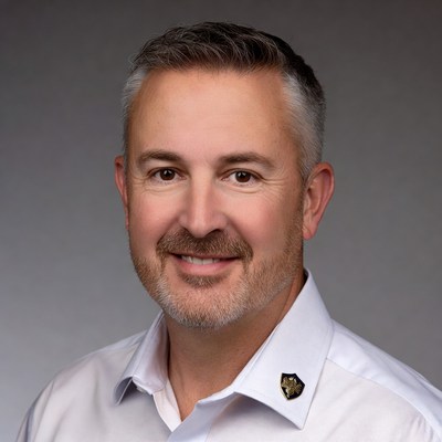 Man smiling with short hair wearing a shirt