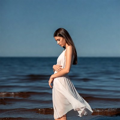 Woman walking by the ocean