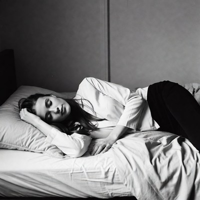 Woman resting on bed in morning light