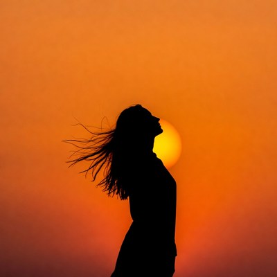 Woman silhouette against sunset