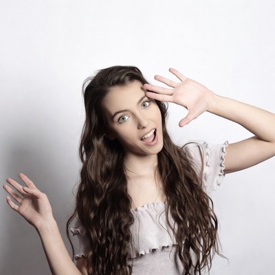 Woman posing with playful expression indoors