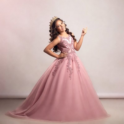 Child in pink dress with crown