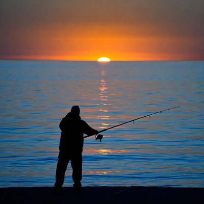 Fishing at sunset by the water