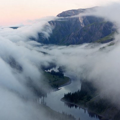 Fog envelops river valley at dawn