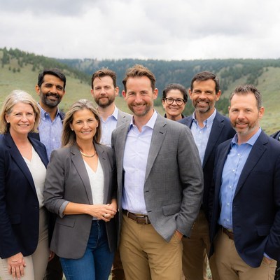 Team gathering on a hillside in summer