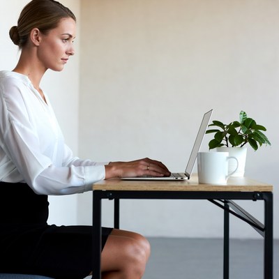 Woman working on laptop at desk