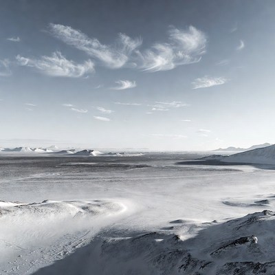 Snowy landscape with clouds at sunset