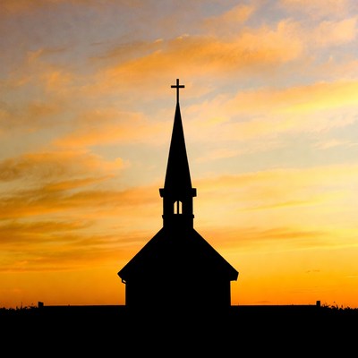 Church silhouette against sunset sky
