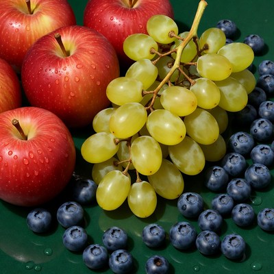 Fresh fruit on green surface