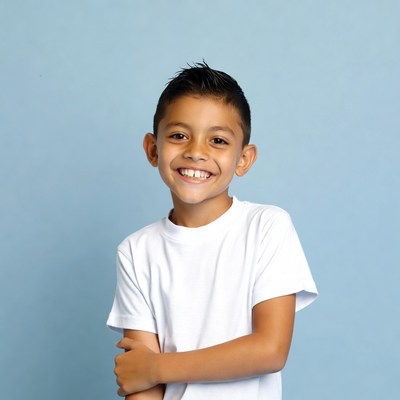 Child smiling against light blue background