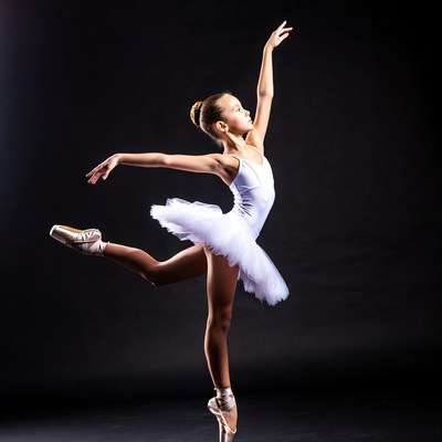 Young dancer performs ballet move in studio