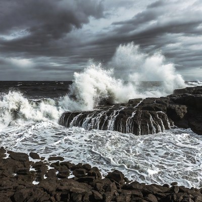 Waves crash against rocky shore