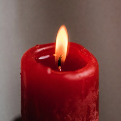 Red candle flame in dark room