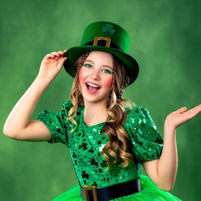 Girl in green costume celebrating holiday