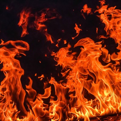 Bright flames dance in darkness
