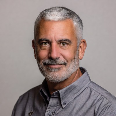 Man with gray hair poses for portrait