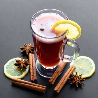 Warm drink with spices and lemon slices