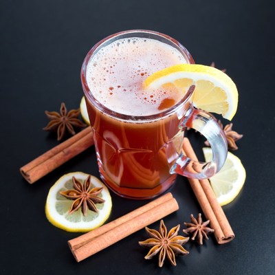 Warm drink with spices and lemon slice