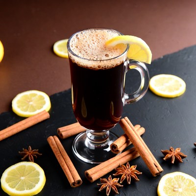 Warm drink with spices and lemon slice