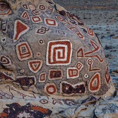 Rock art near desert landscape in sunlight
