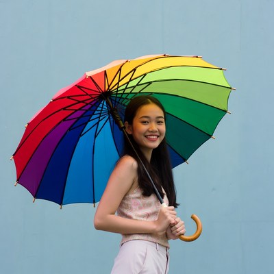 Girl holding colorful umbrella