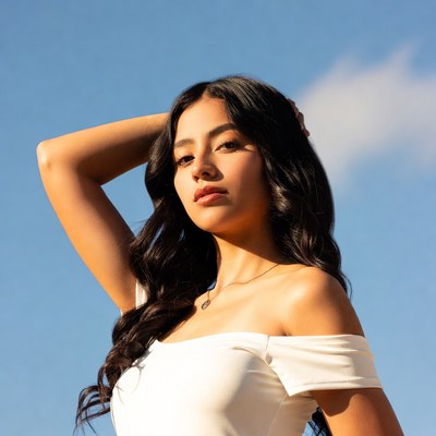 Young woman poses outdoors in sunlight