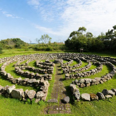 Stone labyrinth in green field