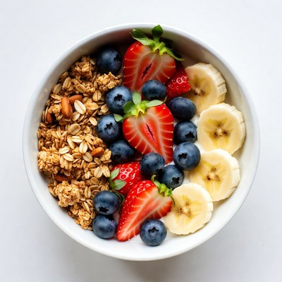 Bowl of fruit and granola served