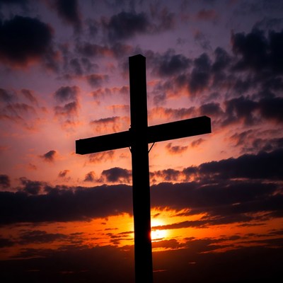 Sunset over a cross silhouette