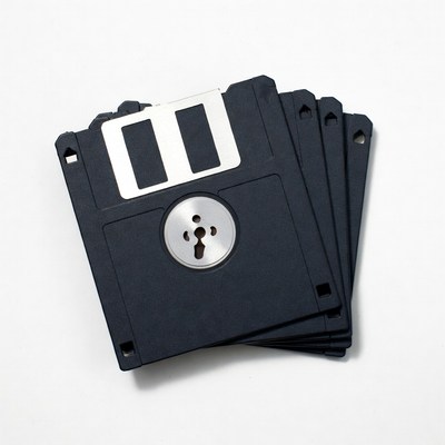 Stack of black floppy disks on white background