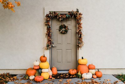 Door decorated for fall season with pumpkins