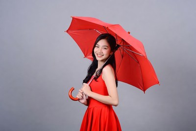 Woman with red umbrella poses