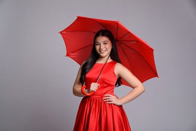 Young girl in red dress with umbrella