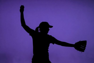 Silhouette of a young athlete preparing to pitch