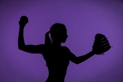 Softball player prepares to throw