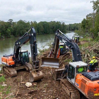 Excavators clearing riverbank area