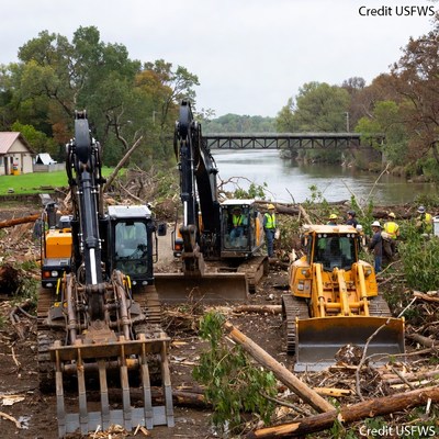 Heavy machinery clearing riverbank debris