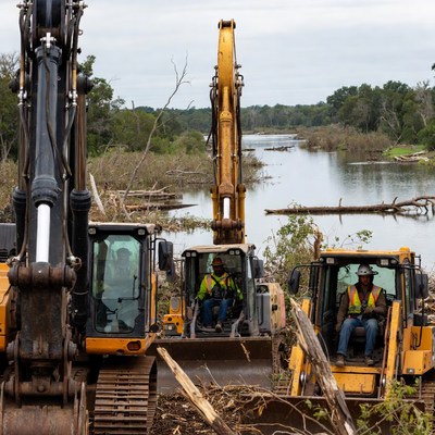 Heavy machinery clear river debris