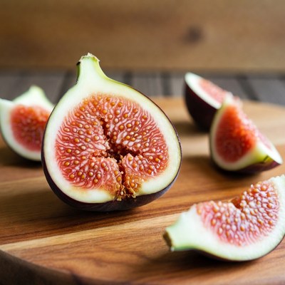 Sliced figs on wooden board