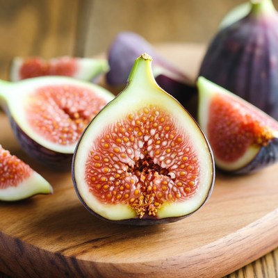 Fresh figs cut on wooden board