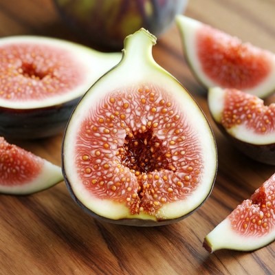 Fresh figs cut on wooden board