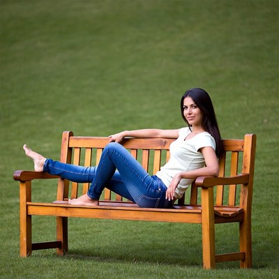 Woman sits on bench in park