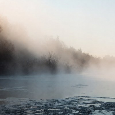 Mist over calm river at dawn