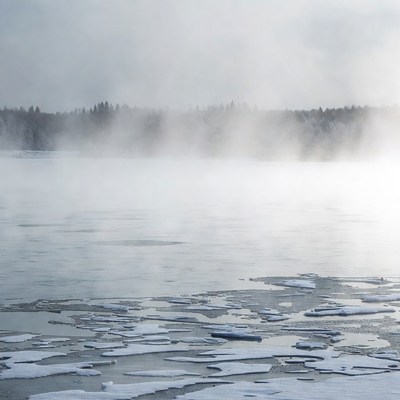 Fog over frozen lake in winter