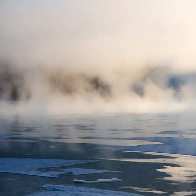 Morning mist over frozen lake